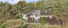 Charmerende sommerhus fra 2004 på stor idyllisk grund
